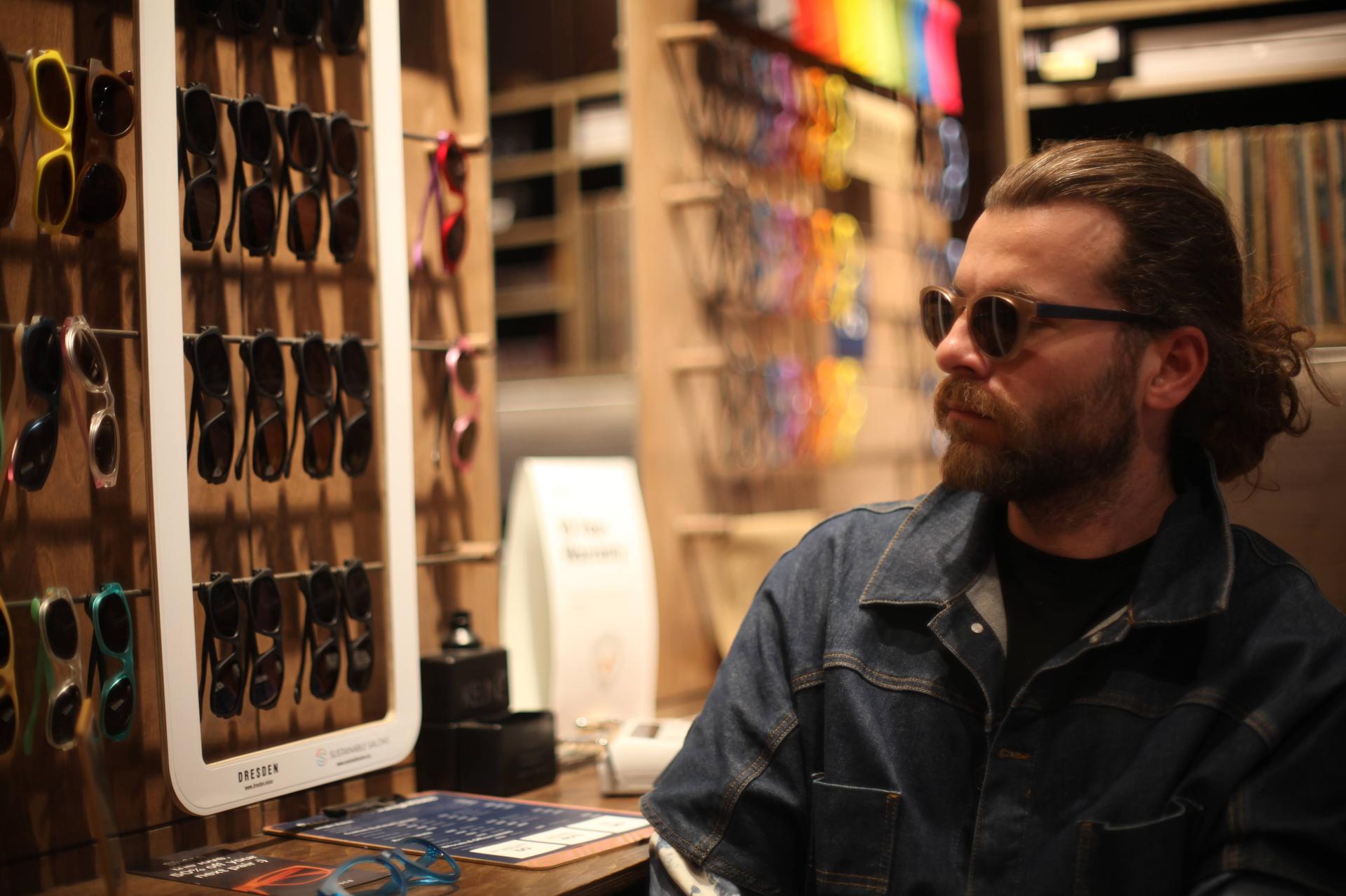 A customer tries on Dresden Vision Canada frames to find the best polarised lenses for reducing harsh glare from Canadian snow and wet winter roads.