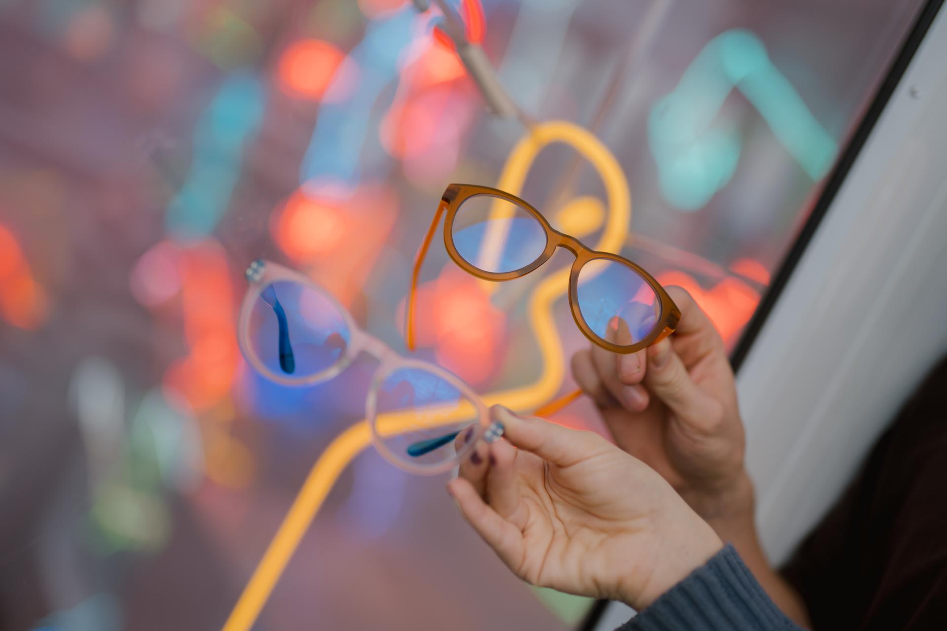 Focused brown framed glasses framed by blurred clear lenses, illustrating smart eyewear innovation at Dresden Vision United States.