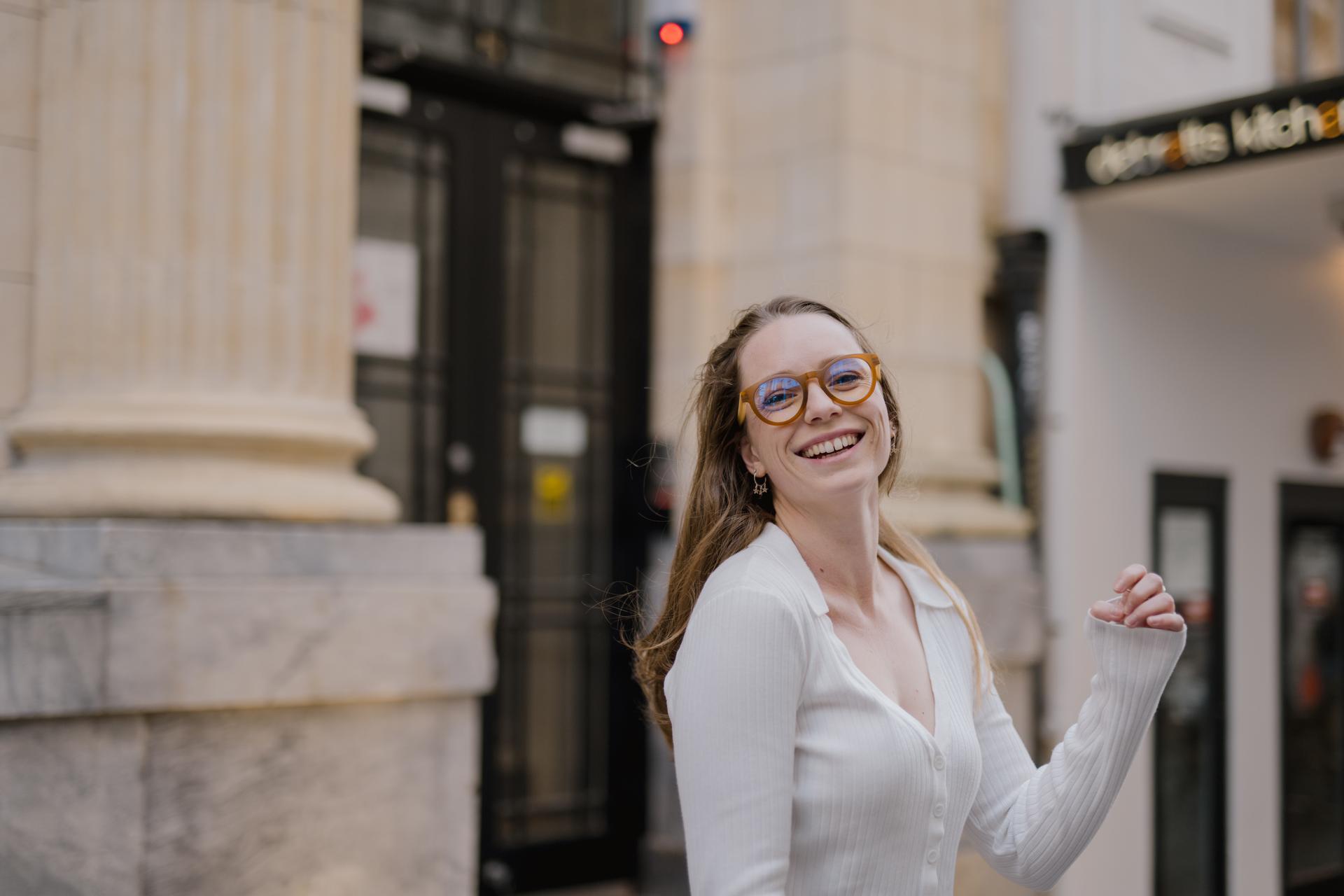 Cheerful woman wearing sustainable eyewear from Dresden Vision United States, showcasing the ease of replacing lenses in frames.