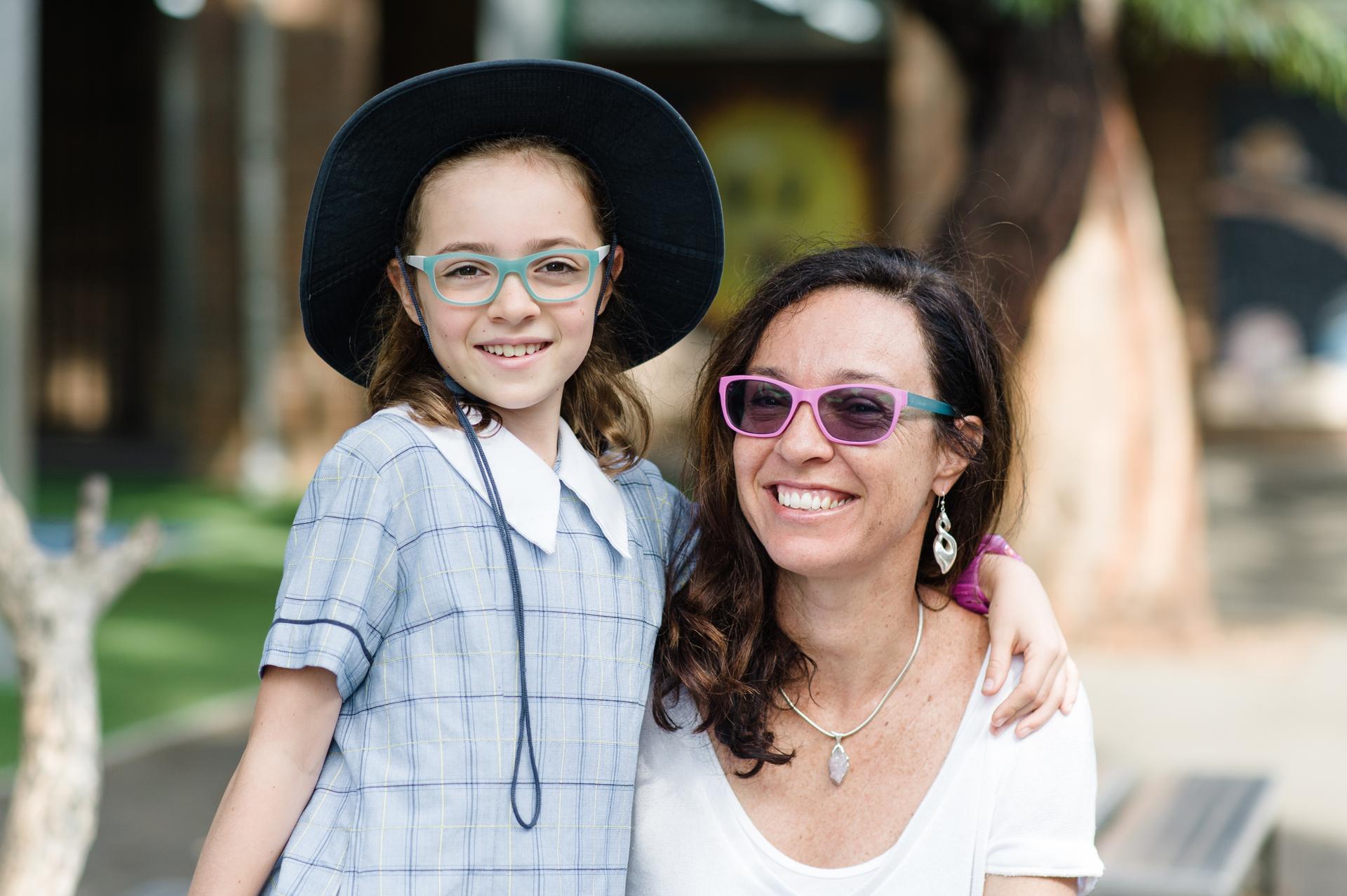 Smiling mother and daughter wearing colourful Dresden Vision Australia glasses, highlighting stylish and affordable kids eyewear.