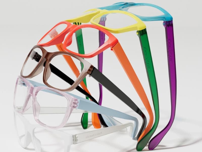 Dresden Vision Australia display of colourful modular glasses frames arranged in a fan shape, showcasing the brands vibrant, interchangeable eyewear system.