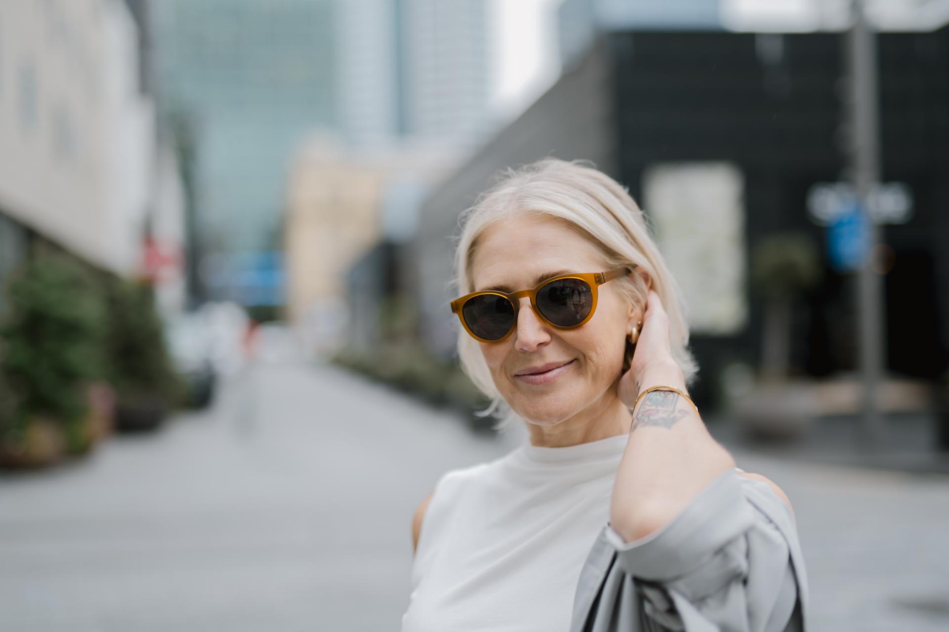 Woman in round-framed brown sunglasses, highlighting Dresden Vision Australias eyewear for bifocal safety glasses.