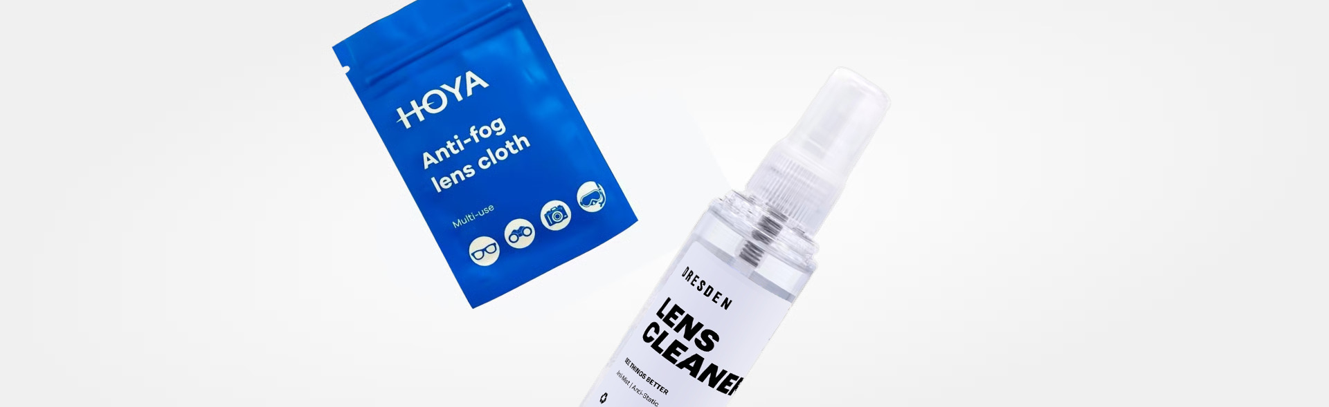 Two Dresden Vision lens care products: a blue package of 'HOYA Anti-fog lens cloth' and a clear spray bottle labeled 'LENS CLEANER,' set against a white background.