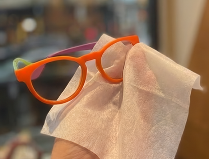Bright Dresden Vision eyeglasses polished with a disposable cleaning wipe, featuring practical lens spray and wipes for daily eyewear maintenance in Canada.