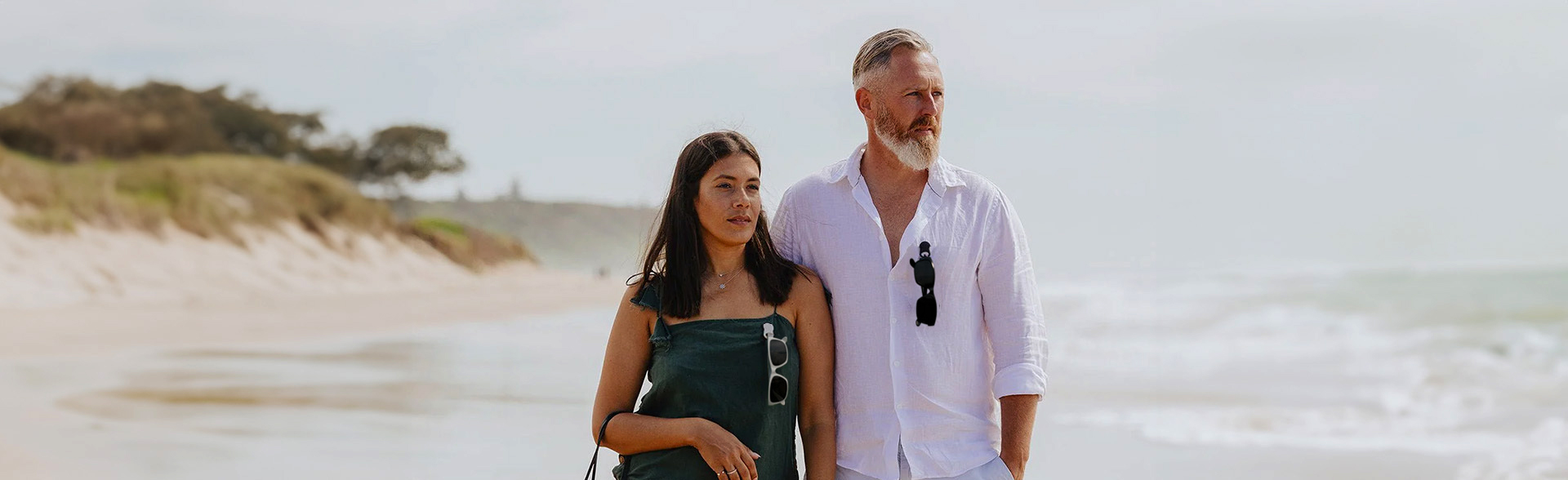 Male and female wearing Dresden Vision glasses attached to their shirts using SPEX magnetic glasses clips, showcasing the convenient and secure way to keep glasses handy.